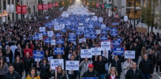 Crowds holding “No Kings” banners during political rally in the United States.
