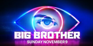 Big Brother Australia 2025 host Mel Tracina on stage with the Big Brother eye logo glowing behind her.”
