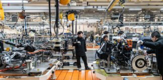 Workers at a Chinese factory during a slowdown as manufacturing activity contracts