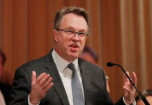 Markets Jump as Fed’s John Williams Signals Possible Near-Term Rate Cut New York Fed President John Williams speaking at an economic policy event.