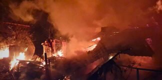 Kyiv skyline shrouded in smoke after Russian missile strikes; civilians seek shelter amid blackouts.