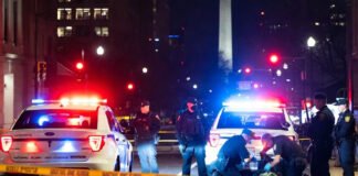 Police and federal agents securing the scene of a shooting near a National Guard recruiting office in Washington, D.C.