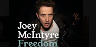 “Joey McIntyre performing live on stage under festive lights at Tinselcolor: Holiday Soundtracks LIVE in Los Angeles.”