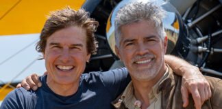 Tom Cruise with SpaceX rocket in background, discussing his upcoming NASA-backed space film during a press event in Los Angeles.