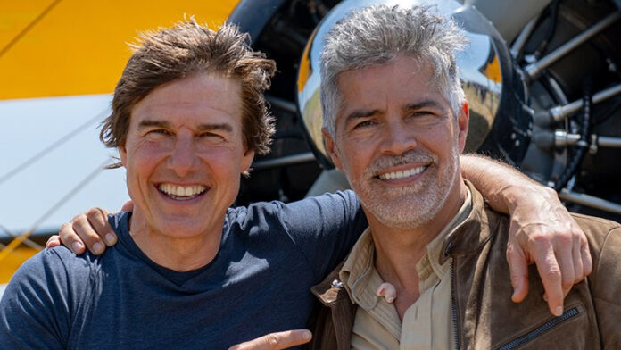 Tom Cruise with SpaceX rocket in background, discussing his upcoming NASA-backed space film during a press event in Los Angeles.