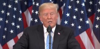 President Trump signing an executive order on AI regulation in the White House.