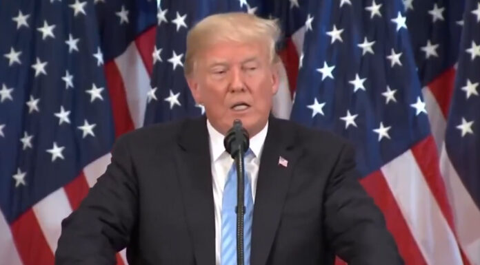 President Trump signing an executive order on AI regulation in the White House.