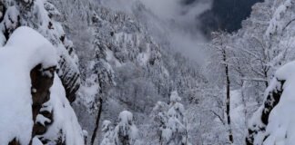Snow-covered Himalayan mountains and foggy plains as India faces a severe cold wave during early December 2025