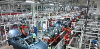 Modern assembly line in a Chinese electric vehicle factory producing multiple EV models