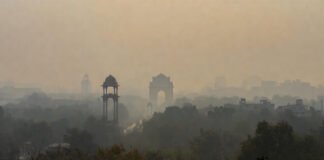 Thick smog shrouding Delhi skyline with India Gate faintly visible on hazy New Year's morning 2026