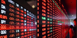 Global stock market screens showing sharp declines after Trump tariff threats.