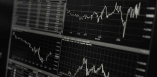 Traders monitoring fluctuating global stock indices on December 1, 2025 amid cautious market sentiment.
