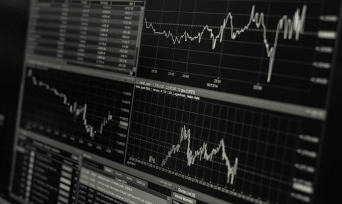 Traders monitoring fluctuating global stock indices on December 1, 2025 amid cautious market sentiment.