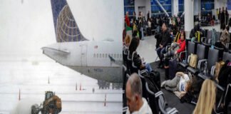 Passengers stranded at JFK Airport due to heavy snowstorm, with canceled flight boards visible
