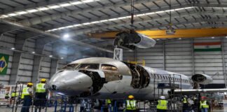 Adani Defence and Embraer executives announcing aircraft manufacturing partnership in India
