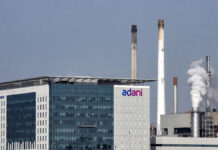 Adani Power Q3 Results: Net Profit Slips to ₹2,488 Crore Despite Stable Operations Adani Power corporate office with power plant infrastructure in the background