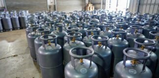Commercial LPG gas cylinders stacked outside an Indian gas agency after price hike