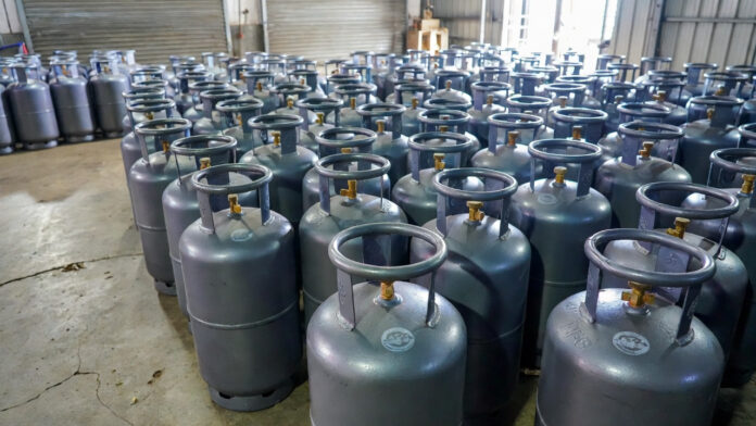 commercial-lpg-cylinder-pri Commercial LPG gas cylinders stacked outside an Indian gas agency after price hike