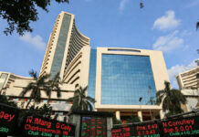 Stock Market to Remain Open on January 15 Despite Maharashtra Holiday; NSE Announces Settlement Holiday NSE building in Mumbai with stock market screens displaying trading and settlement holiday notice