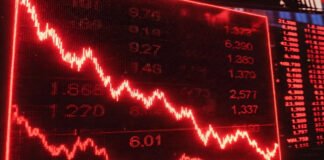 Wall Street screens showing market crash after Trump’s tariff warning