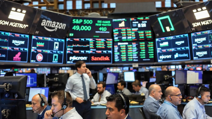 wall-street-records-tech-ra Wall Street stock market trading floor and closing bell with rising index screens