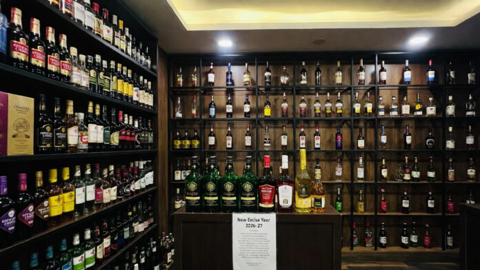 delhi-liquor-license-fee-hi Liquor bottles displayed at a Delhi store as excise license fees increase by 10% for 2026–27