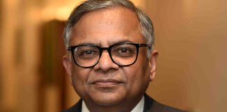 N. Chandrasekaran speaking at a corporate event with Tata Sons headquarters in the background