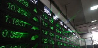 Digital display board showing Sensex and Nifty gains inside Bombay Stock Exchange