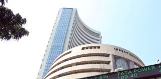 Bombay Stock Exchange building with Sensex ticker showing gains during Thursday trading session