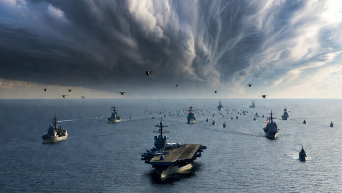 us-iran-tensions-carrier-ho US aircraft carrier and Iranian naval drill illustrating rising tensions