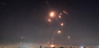 Missile defense system intercepting incoming ballistic missiles over Tel Aviv following US-Israel strikes on Iran