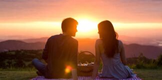 Couple enjoying romantic sunset picnic on Valentine’s Day