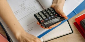 Person using compound interest calculator on laptop to calculate personal loan EMI and interest