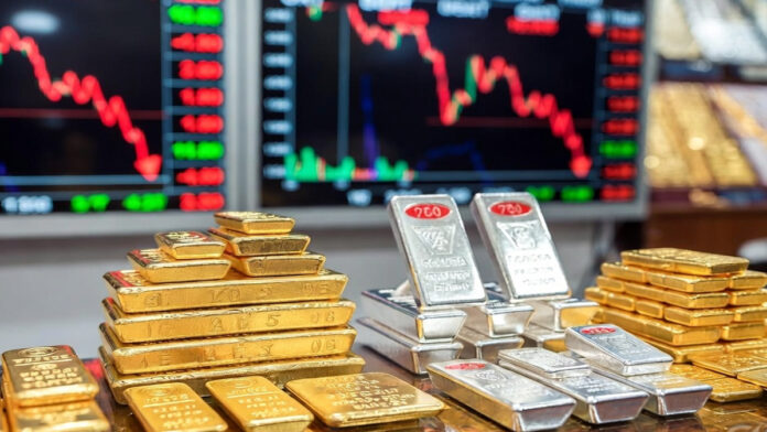 gold-silver-price-fall-delh Gold and silver bars displayed in a jewelry market as bullion prices fall sharply in Delhi after Holi