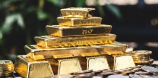 Gold bars and silver coins reflecting surge in precious metal prices amid West Asia tensions