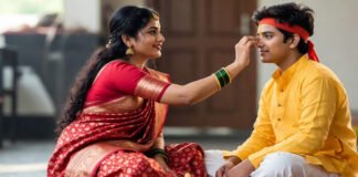 Holi Bhai Dooj ritual with sister applying tilak on brother during Hindu festival