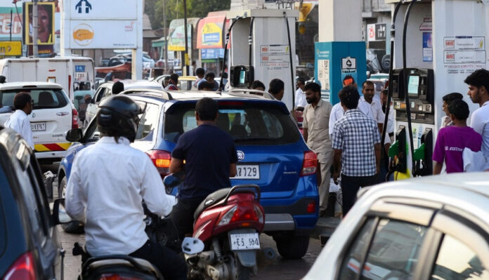 Petrol pump in India showing increased fuel prices with customers refueling vehicles