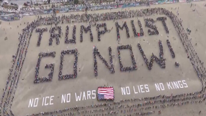 Protesters marching in New York with No Kings signs against Trump policies
