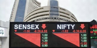 Electronic stock market display board showing Sensex and Nifty sharply falling during early trading in India.