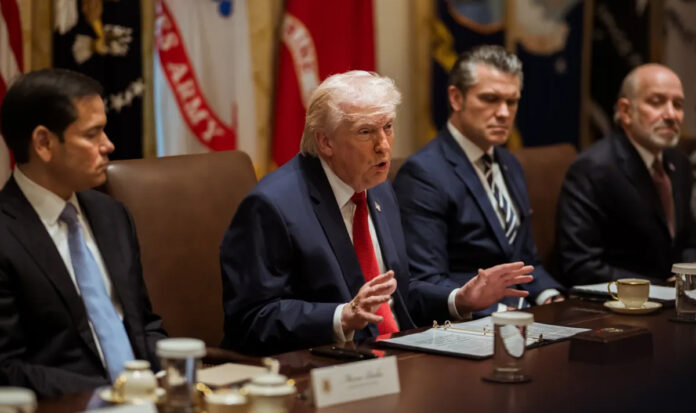 Trump-College-Sports-Execut Donald Trump signing executive order on college sports reforms with documents and US flag