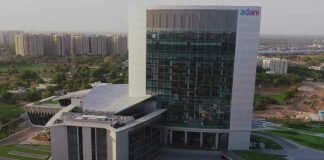 Adani Enterprises infrastructure projects including airport and industrial facilities showing financial performance impact