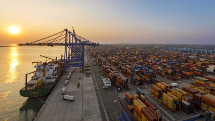 Adani Ports Q4 FY26 earnings growth and cargo milestone Adani Ports cargo terminal with containers and ships showing strong financial growth in Q4 FY26