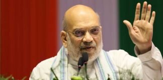 Amit Shah addressing a large BJP rally in Darjeeling with crowd and party flags