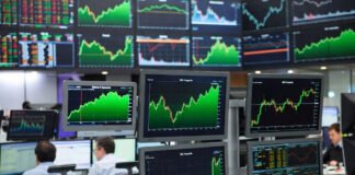 Asian stock markets trading screens showing Nikkei Kospi Hang Seng gains
