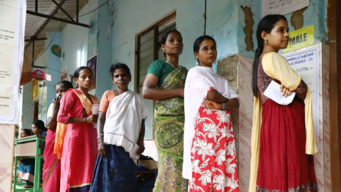 High Voter Turnout in India Assembly Elections 2026 Voters standing in long queues during Assembly Elections 2026 in India