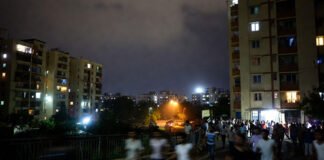 Earthquake tremors in Delhi NCR April 2026 people outside buildings night scene