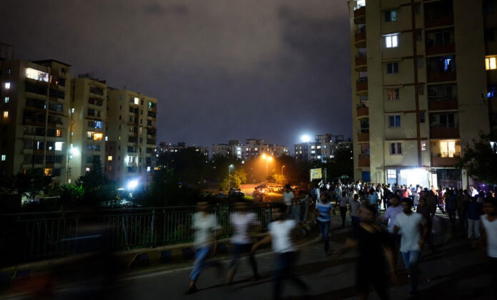 earthquake-delhi-ncr-april- Earthquake tremors in Delhi NCR April 2026 people outside buildings night scene