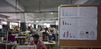 Textile factory workers in India with export decline concept and garments production line