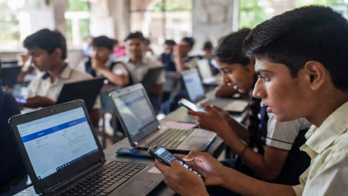 up-board-result-2026-studen UP Board Result 2026 students checking results online laptop mobile anxious crowd