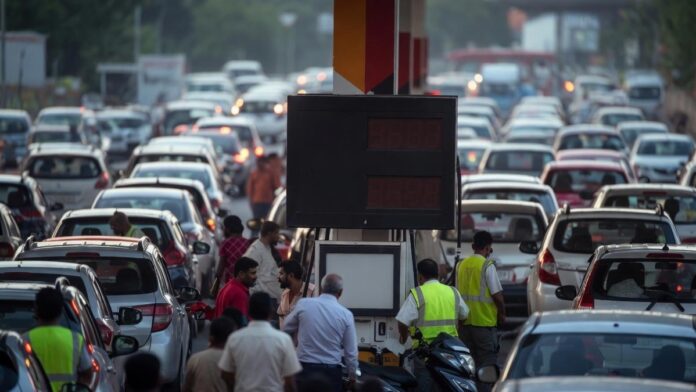 India Fuel Price Hike 2026 Amid Rising Crude Oil Prices Petrol pump worker filling fuel at an Indian gas station as petrol and diesel prices rise in major cities